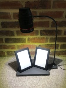 Slate with camera lens light source.