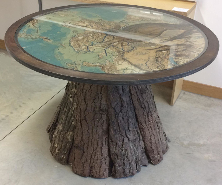 Round wooden table with glass top.